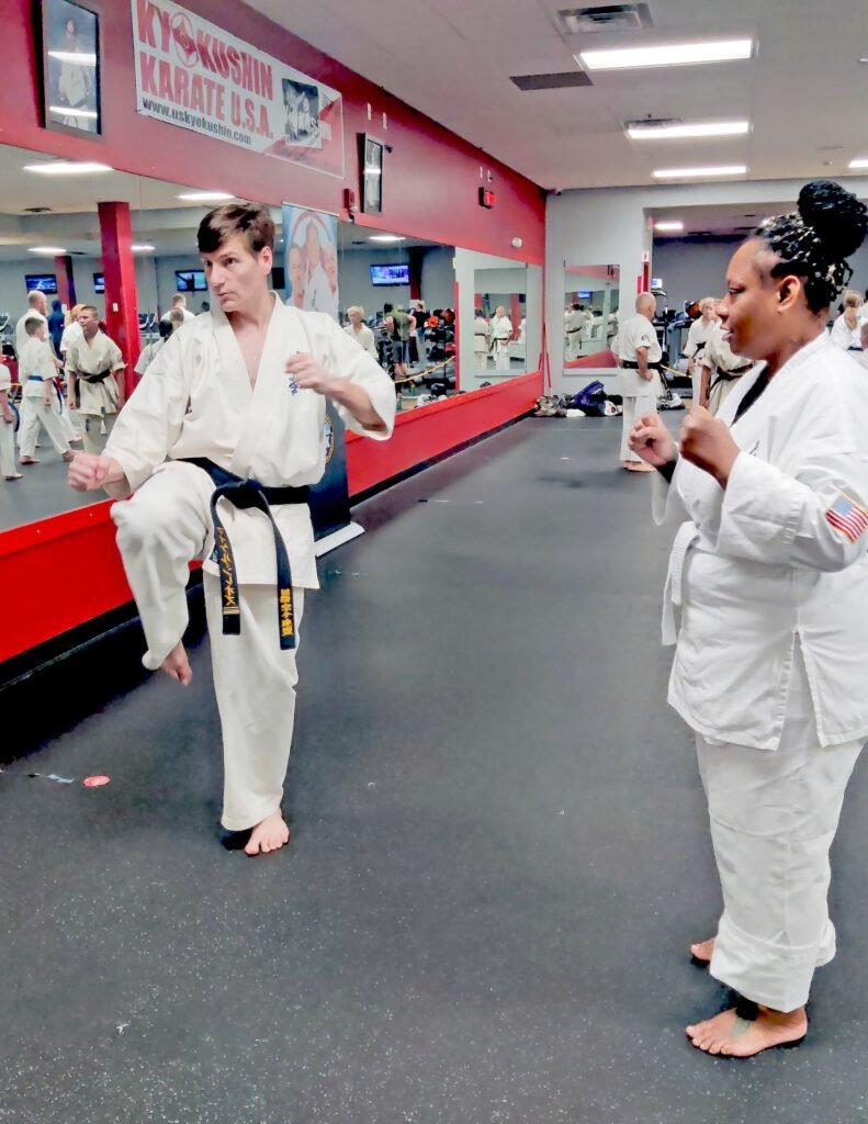 Sensei Mike Theiros demonstrating a kick for students at Kyokushin Karate USA in Rochester, New York